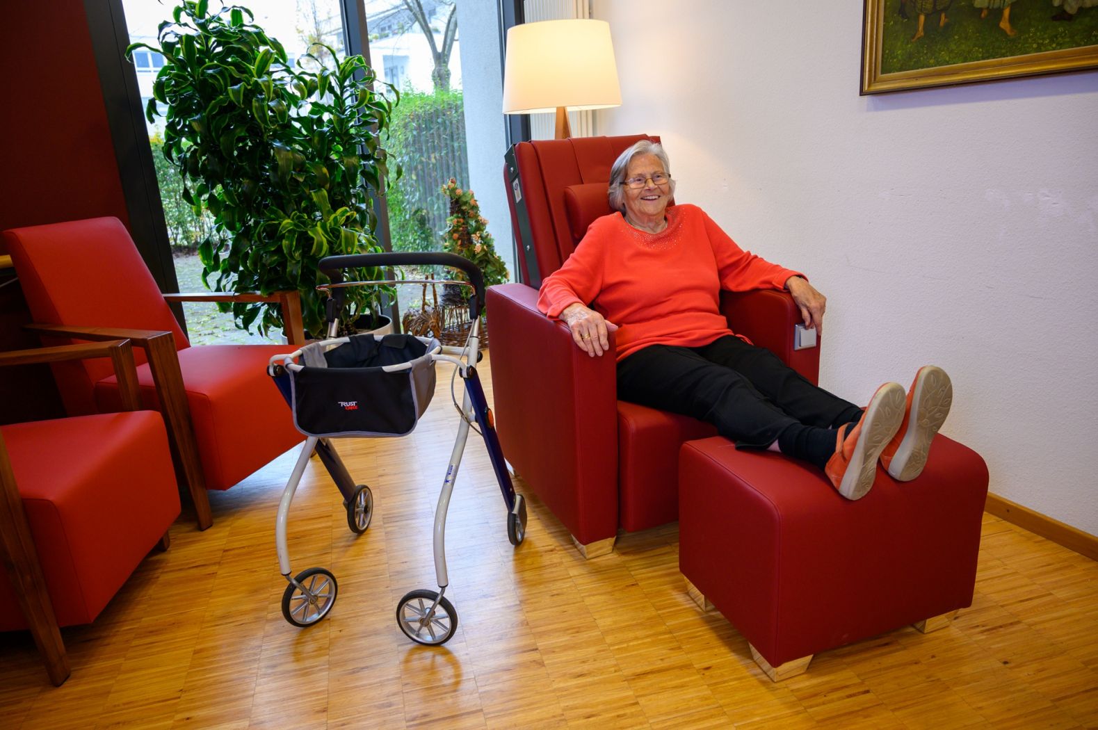 Eine Bewohnerin sitzt auf dem Massagesessel