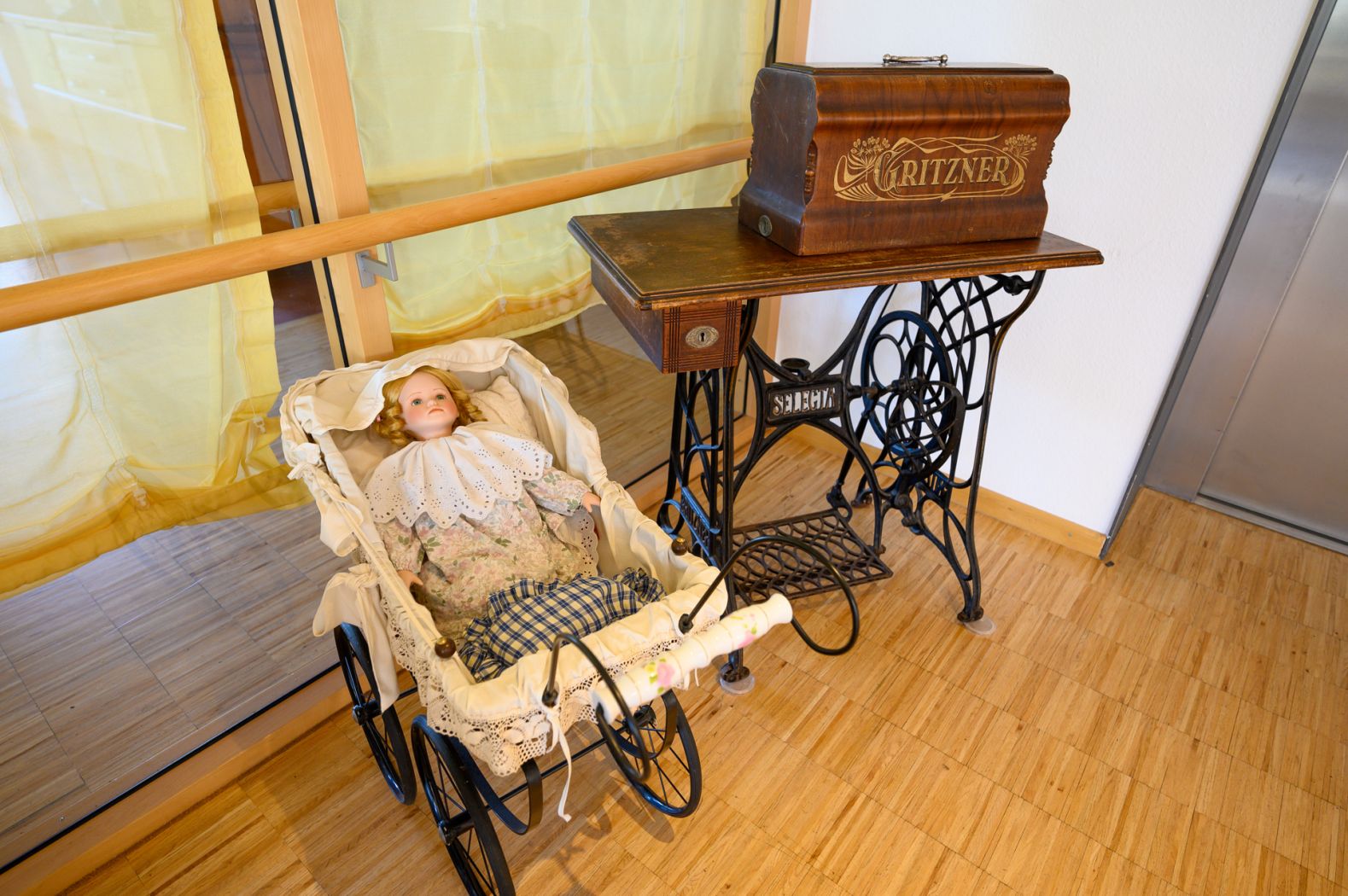 Nostalgische Nähmaschine und Puppenwagen